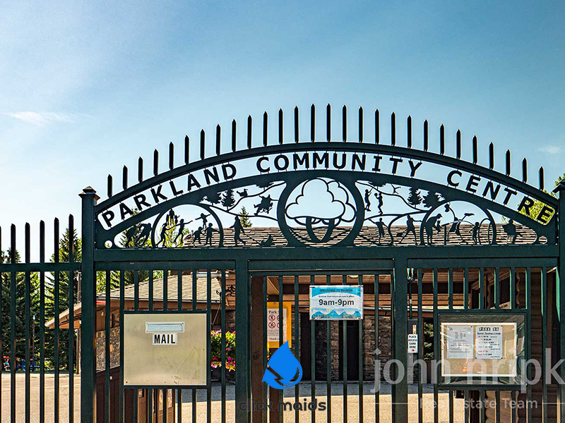 Parkland Community Centre sign on decorative black metal gate, open 9am-9pm.