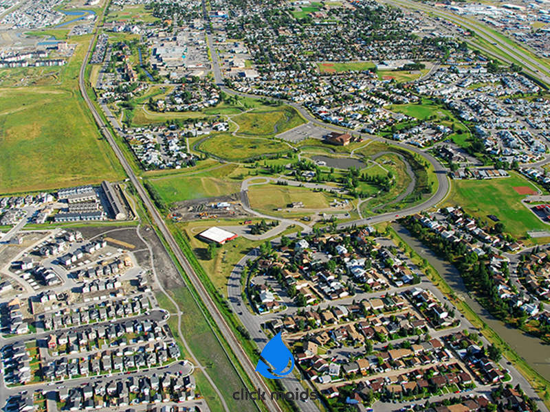 Aerial view of Airdrie Alberta showing suburban neighborhoods, parks, and winding roads across the city landscape
